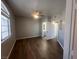 Spacious main bedroom featuring dark floors, neutral walls, a ceiling fan, and bathroom access at 1830 N Buffalo Dr # 2022, Las Vegas, NV 89128