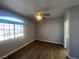 Comfortable main bedroom featuring dark floors, neutral walls, and a window with a view at 1830 N Buffalo Dr # 2022, Las Vegas, NV 89128