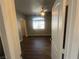 Spacious main bedroom featuring dark floors, neutral walls, a window, and a hallway view at 1830 N Buffalo Dr # 2022, Las Vegas, NV 89128