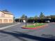 Well maintained parking area offering easy access and a welcoming landscape buffer with a designated keep right sign at 1830 N Buffalo Dr # 2022, Las Vegas, NV 89128