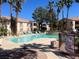 Relaxing pool area with comfortable lounge chairs, lush palm trees, and a serene fountain perfect for community enjoyment at 1830 N Buffalo Dr # 2022, Las Vegas, NV 89128