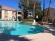 Relaxing pool area with comfortable lounge chairs, lush palm trees, and a serene fountain perfect for community enjoyment at 1830 N Buffalo Dr # 2022, Las Vegas, NV 89128