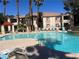 Relaxing pool area with comfortable lounge chairs, lush palm trees, and a serene fountain perfect for community enjoyment at 1830 N Buffalo Dr # 2022, Las Vegas, NV 89128