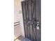 Close-up of the security door with decorative scrollwork and a modern keypad lock at 1830 N Buffalo Dr # 2022, Las Vegas, NV 89128