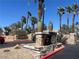 Stone monument sign with palm trees, decorative urns, and information about Pacific Legends community at 1830 N Buffalo Dr # 2022, Las Vegas, NV 89128