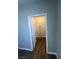 Walk-in closet featuring dark floors, neutral walls, an open door, and built-in shelving at 1830 N Buffalo Dr # 2022, Las Vegas, NV 89128
