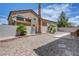 Spacious gravel backyard with a patio and small palm trees, offering a serene outdoor space at 1952 W Hammer Ln, North Las Vegas, NV 89031