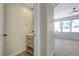 Chic powder room with a modern vanity, stylish mirror, and views into the main living area at 1952 W Hammer Ln, North Las Vegas, NV 89031