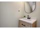 Stylish powder room featuring a modern vanity with a wood finish and a sleek faucet at 1952 W Hammer Ln, North Las Vegas, NV 89031