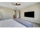 Bright bedroom with television, bed and mirror, and doorway to bath area at 1952 W Hammer Ln, North Las Vegas, NV 89031