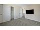 Bedroom features carpeted floors, standard closet, interior door, and modern wall-mounted television at 1952 W Hammer Ln, North Las Vegas, NV 89031