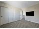 A bright bedroom with neutral tones, a mounted TV, and a large closet, perfect for relaxation at 1952 W Hammer Ln, North Las Vegas, NV 89031