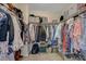 A walk-in closet offers ample storage with rods, shelves and various containers for organizing belongings at 1952 W Hammer Ln, North Las Vegas, NV 89031