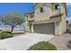Attractive two-story home with an attached garage, neutral stucco, and easy-care landscaping at 1952 W Hammer Ln, North Las Vegas, NV 89031