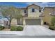 Charming two-story home with a neutral color scheme, desert landscaping, and an attached two-car garage at 1952 W Hammer Ln, North Las Vegas, NV 89031