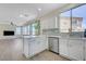 Open-concept kitchen with white cabinetry and stainless steel dishwasher adjoining the living area at 1952 W Hammer Ln, North Las Vegas, NV 89031