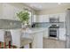 Bright kitchen with white cabinetry, stainless steel appliances, and a stylish backsplash at 1952 W Hammer Ln, North Las Vegas, NV 89031