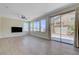 Light-filled living room with wood-look flooring, large windows, and sliding glass door access to the backyard at 1952 W Hammer Ln, North Las Vegas, NV 89031