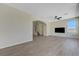 Open living space with wood-look flooring, a modern ceiling fan, and stairway access in a neutral color palette at 1952 W Hammer Ln, North Las Vegas, NV 89031