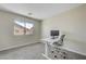 Office area features a sleek white desk, ergonomic chair, and a bright window for natural light at 1952 W Hammer Ln, North Las Vegas, NV 89031