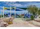 Community playground features slides, climbing structures, and colorful shade canopies for year-round fun at 1952 W Hammer Ln, North Las Vegas, NV 89031