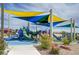 Community playground features slides, climbing structures, and colorful shade canopies for year-round fun at 1952 W Hammer Ln, North Las Vegas, NV 89031