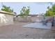 Backyard features a patio area, block wall, mature trees, and desert landscaping at 2001 E Mcwilliams Ave, Las Vegas, NV 89101