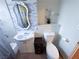 A well-lit bathroom features a decorative mirror, sink, and toilet at 2001 E Mcwilliams Ave, Las Vegas, NV 89101
