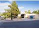 View of the exterior of the property showing mature trees, covered parking and desert landscaping at 2001 E Mcwilliams Ave, Las Vegas, NV 89101
