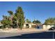 A single-story home, featuring mature trees and a yard enclosed by a chain-link fence at 2001 E Mcwilliams Ave, Las Vegas, NV 89101