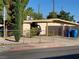 Single-story home with a yard enclosed by a chain-link fence and block wall with mature trees at 2001 E Mcwilliams Ave, Las Vegas, NV 89101