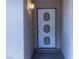 Close-up of front door with decorative panels and a classic light fixture at 2001 E Mcwilliams Ave, Las Vegas, NV 89101
