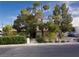 Charming single-story home with mature trees, trimmed hedges, and a well-kept front yard at 2001 E Mcwilliams Ave, Las Vegas, NV 89101