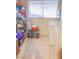 This laundry room features tile floors, a window, and a wire shelf for storage at 2001 E Mcwilliams Ave, Las Vegas, NV 89101