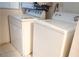 This laundry area is equipped with a white washing machine and dryer set at 2001 E Mcwilliams Ave, Las Vegas, NV 89101