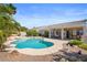 Private backyard oasis with a sparkling pool, lush landscaping, a covered patio, and ample space for outdoor entertainment at 2158 Shubert Ave, Henderson, NV 89052