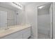Bathroom with a single sink vanity, a large mirror, and a door that leads to the tub and toilet area at 2158 Shubert Ave, Henderson, NV 89052