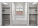 Bright bathroom features a soaking tub nestled between two closets with a window at 2158 Shubert Ave, Henderson, NV 89052