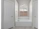 Bathtub with tiled surround, window, and two closets for optimal storage at 2158 Shubert Ave, Henderson, NV 89052