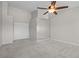 Neutral bedroom with ceiling fan, carpet, closet, and white doors at 2158 Shubert Ave, Henderson, NV 89052