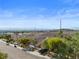 A well-maintained street with homes and landscaped front yards under a clear blue sky and beautiful mountain backdrop at 2158 Shubert Ave, Henderson, NV 89052