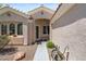 Inviting front entry with a covered porch and well-maintained desert landscaping, complete with a small bench at 2158 Shubert Ave, Henderson, NV 89052