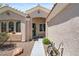 Inviting front entry with a covered porch and well-maintained desert landscaping, complete with a small bench at 2158 Shubert Ave, Henderson, NV 89052