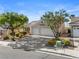 Inviting single-story home featuring mature landscaping, a well-kept front yard, and a spacious two-car garage at 2158 Shubert Ave, Henderson, NV 89052