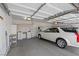 Spacious garage with ample storage, workbench, and a car parked inside at 2158 Shubert Ave, Henderson, NV 89052