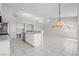 Open kitchen with white cabinets and tile floors offers lots of storage and workspace at 2158 Shubert Ave, Henderson, NV 89052