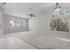 Open-concept living room boasts abundant natural light with a ceiling fan and a mix of carpet and tile floors at 2158 Shubert Ave, Henderson, NV 89052