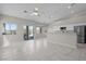 Open-concept living space with tile floors, white walls, and a ceiling fan, seamlessly connecting indoor and outdoor living areas at 2158 Shubert Ave, Henderson, NV 89052