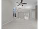 Bright living room with neutral walls, arched windows, and tile and carpet flooring at 2158 Shubert Ave, Henderson, NV 89052