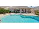 A sparkling blue pool with a tanning ledge and steps leading into the refreshing water at 2158 Shubert Ave, Henderson, NV 89052